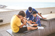 © Fabio Principe - Teenagers friends using smartphone together. Smiling teens browsing social media online. Boys watching video streaming on mobile phone. Youth, technology, generation z lifestyle communication concept