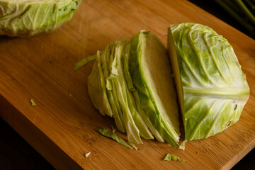 Wall Mural - cut white cabbage on wooden board at home