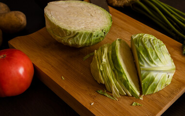 Wall Mural - cut white cabbage on wooden board at home