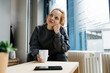 © contrastwerkstatt - young redhead woman takes break in her office