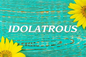 Wall Mural - IDOLATROUS - text, yellow flowers, sunflowers, wooden background (copy space).