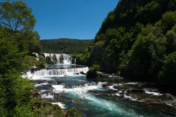 a magnificent waterfall called strbacki buk on the beautifully clean and drinking Una river in Bosnia and Herzegovina in the middle of a forest.