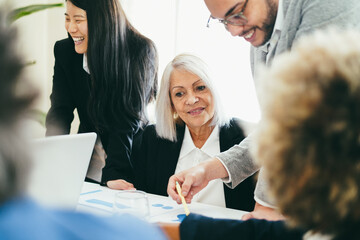 Multiracial business people working inside bank office - Soft focus on senior woman face