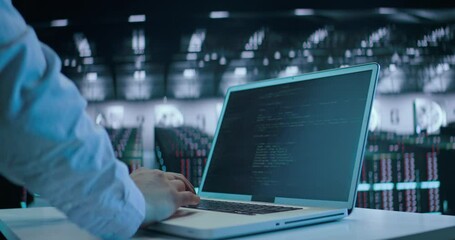 Caucasian male, IT technician using laptop, doing maintenance and diagnostics in the Server Room.