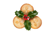 Three Christmas Mince Pies With Holly Isolated Against A Flat Background.