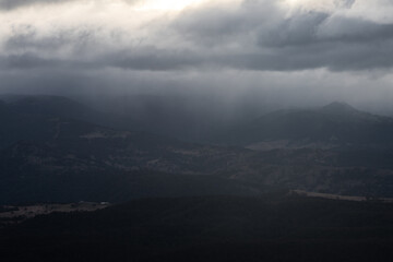 Wall Mural - stormy and cloudy view in the mountain valley.