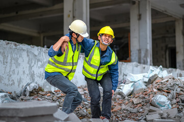 Wall Mural - Construction supervisors or engineers help construction workers who have knee and leg injuries, caused by accidents at the construction site.