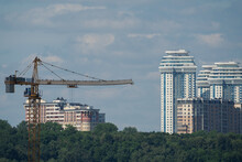 Urban Landscape With High-rise Buildings, Construction Crane And TV Tower