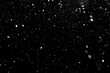falling snow out of focus, isolated on a black background