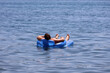 © Oleg - Woman in bikini swimming on inflatable mattress in sea water. Summer relax and beach vacation