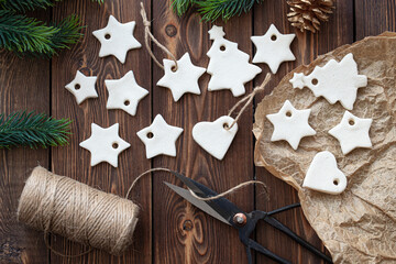 christmas decoration made of salted dough in the shape of stars and hearts lie on a wooden table.