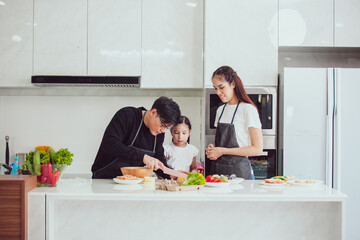 asian family cooking at home. happy family cooks together in the kitchen home recreation and weekend