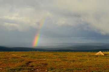  Kaunispää Saariselkä Finland. After the thunder, the sun shines again and a rainbow appears against the dark sky