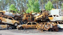 2022 - Rising Aerial Of Wrecked And Burned Cars In The Car Cemetery Sitting In A Pile Many With Bullet Holes From Russian Aggression, Irpin Ukraine.