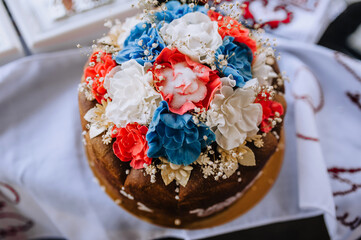 Wall Mural - Beautiful round, decorated with flowers and salt, wedding Ukrainian loaf with a towel. Food photography.