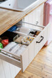 wooden drawer with dishwashing tablets at kitchen