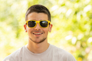 Canvas Print - portrait of young man with sunglasses outdoors