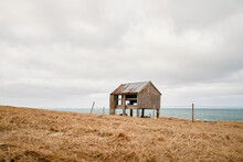 Shabby Shed Near Sea On Cloudy Day