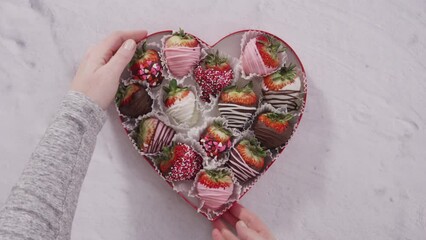 Sticker - Flat lay. Step by step. Heart-shaped box with chocolate dipped strawberries.