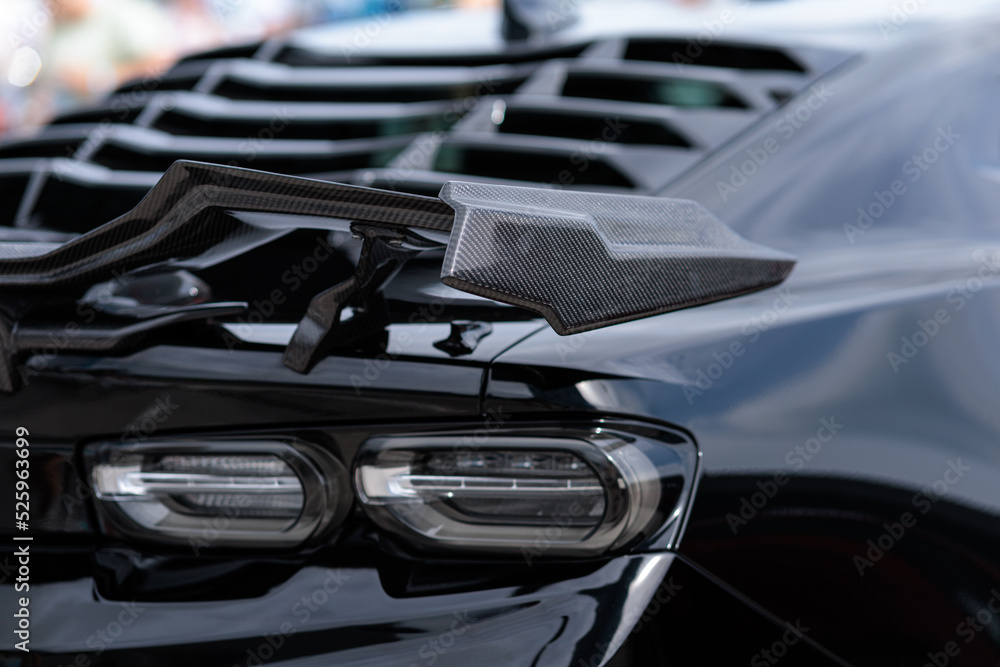 Luxury black sports car fragment, rear aerodynamics carbon spoiler and ...