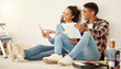 © Anela Ramba/peopleimages.com - Paint, painting and room color choice for home improvement project for home, apartment or property. New home upgrade with happy couple with a smile on the floor excited about new home maintenance job