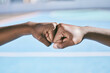 © Siphosethu F/peopleimages.com - Closeup of hands, fist bump and the teamwork of two athletic, sporty, and active male athletes. Team of black people, friends or teammates working together showing respect, collaboration and support