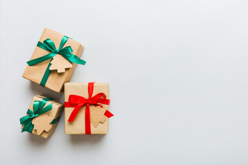 Wall Mural - wrapped christmas or other holiday handmade present in paper with colored ribbon. Present box, decoration of gift on colourfull table, top view with copy space