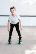 © ADDICTIVE STOCK - Boy riding roller skates on street