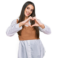 Wall Mural - Young beautiful woman wearing casual white shirt smiling in love showing heart symbol and shape with hands. romantic concept.