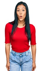 Sticker - Beautiful hispanic woman wearing casual clothes afraid and shocked with surprise expression, fear and excited face.