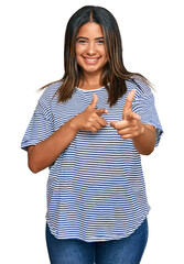 Poster - Young latin girl wearing casual clothes pointing fingers to camera with happy and funny face. good energy and vibes.