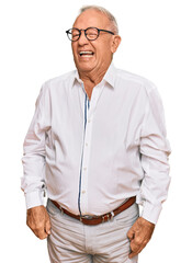 Canvas Print - Senior caucasian man wearing business shirt and glasses winking looking at the camera with sexy expression, cheerful and happy face.