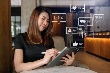 Wall Mural - asian woman typing tablet with laptop computer of social media and marketing virtual icons screen co