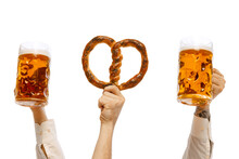 Male Hands With Pretzel And Mugs With Foamy Lager Beer Isolated Over White Studio Background. German And Bavarian Holidays