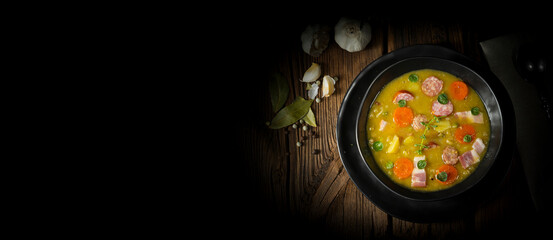 Wall Mural - Hearty rustic pea soup with bacon and sausage