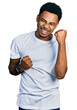 © Krakenimages.com - Young african american man wearing casual white t shirt celebrating surprised and amazed for success with arms raised and eyes closed. winner concept.