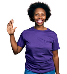 Canvas Print - African american woman with afro hair wearing casual purple t shirt showing and pointing up with fingers number five while smiling confident and happy.