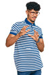 © Krakenimages.com - Young arab man wearing casual clothes and glasses disgusted expression, displeased and fearful doing disgust face because aversion reaction. with hands raised