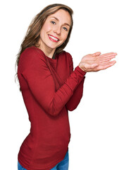 Sticker - Young blonde woman wearing casual clothes pointing aside with hands open palms showing copy space, presenting advertisement smiling excited happy