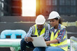 © amorn - Group of African American engineer working in sewer pipes area at construction site. Male engineer and woman engineer discussing for maintenance sewer pipes, water tank on rooftop of building