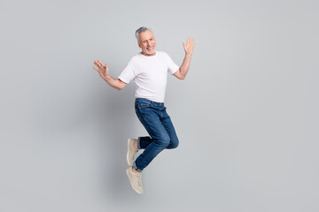 Sticker - Full length body size view of attractive cheerful successful man jumping having fun isolated over grey pastel color background