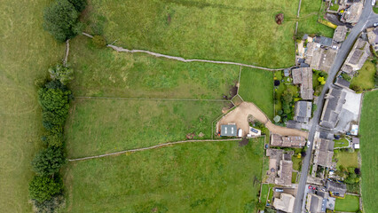 Wall Mural - Aerial photo of the beautiful village of Thoralby in the Richmondshire district of North Yorkshire in the UK, showing the small British village and surrounding green fields in the summer time