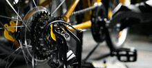 Bicycle Maintenance And Repair. Mechanic Working In Bike Service Workshop. Gear Closeup. Banner With Copy Space