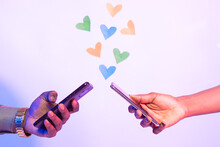 two black people using their phones with love shapes in the background, online dating concept