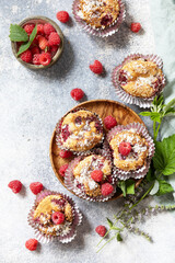 Wall Mural - Healthy dessert. Vegan gluten-free pastry. Oatmeal banana muffins with raspberry and coconut flakes on a stone table. View from above.