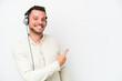© luismolinero - Telemarketer caucasian man working with a headset isolated on white background pointing back