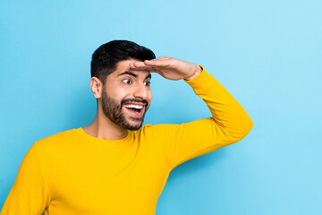 Sticker - Photo of funny interested guy dressed yellow pullover looking far away empty space arm forehead isolated blue color background