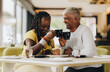 © Jacob Lund - Senior couple enjoying themselves in a coffee shop