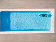 © Cavan Images - girl in swimming pool aerial drone view from above