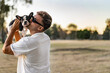 © Cavan Images - Handsome young man holding up and kissing a french bulldog.